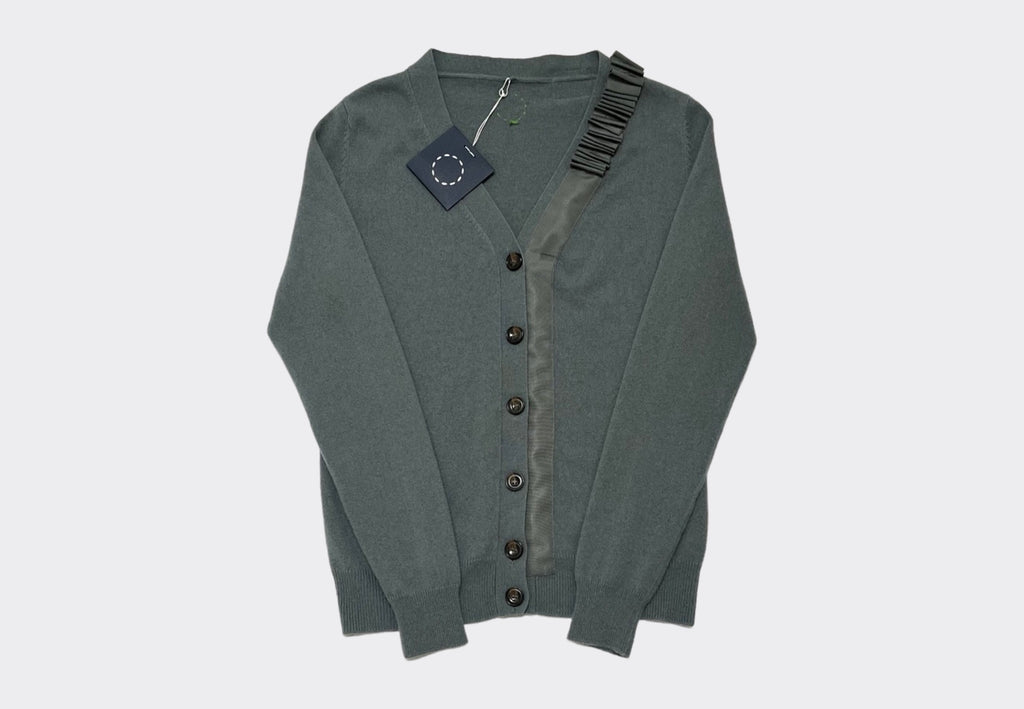 Front product shot of green grey v neck cashmere cardigan with buttons down front and ruflfle grosgrain detail on one side by Irish knitwear brand Sphere One