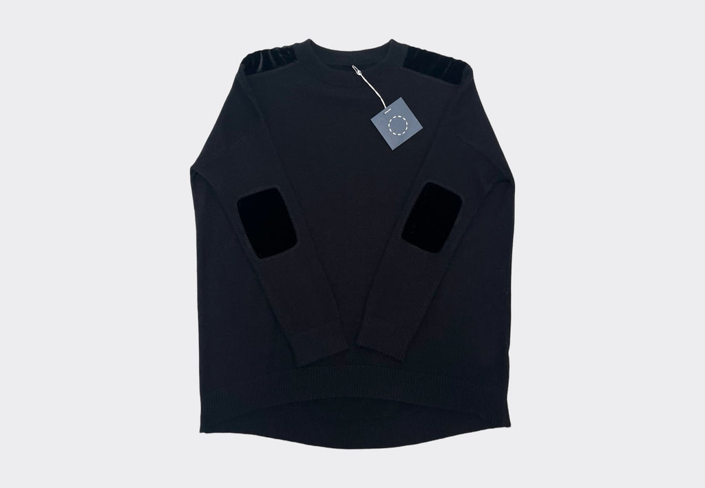 Front product flat lay black round neck cashmere sweater with black velvet shoulder and elbow patches, navy Sphere One swing tag visible