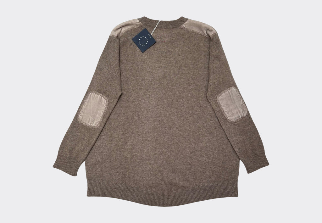 Light brown coloured long sleeve round neck cashmere sweater with velvet elbow and shoulder patches on a light gray background and circle of stitches logo at back neck
