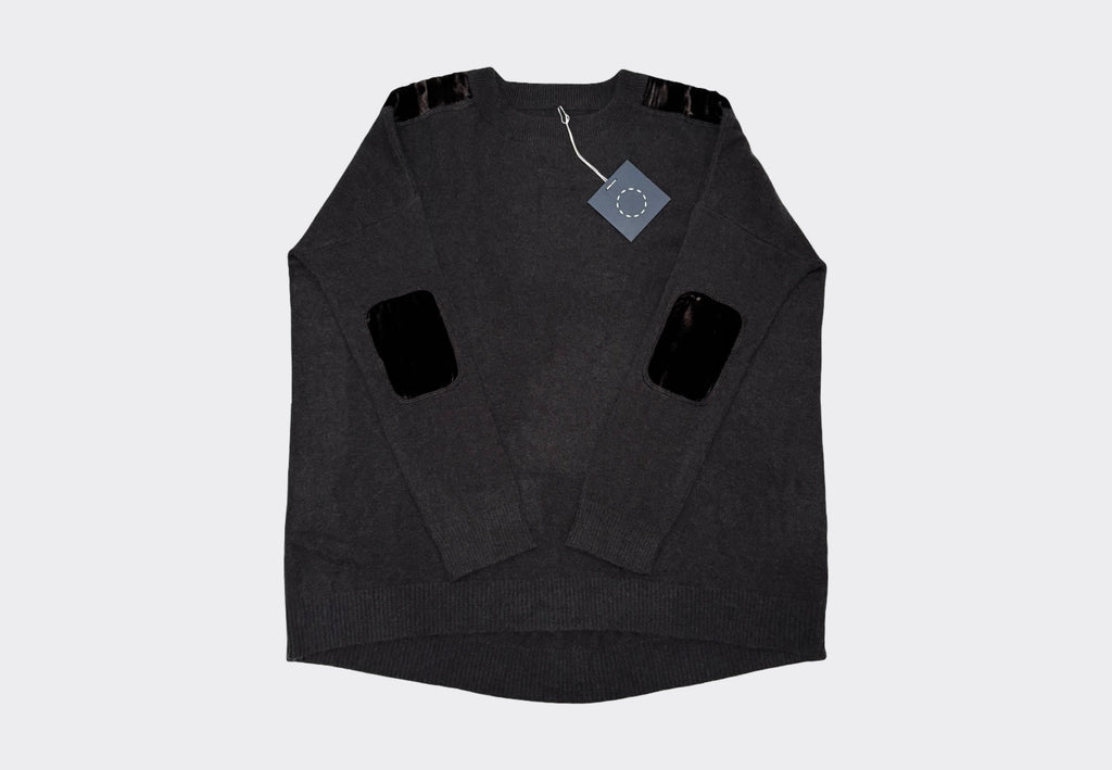 Dark brown peat coloured long sleeve round neck cashmere sweater with velvet elbow and shoulder patches on a light gray background