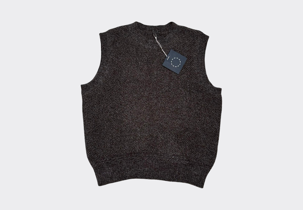 Dark gray sleeveless sweater vest on a light gray background