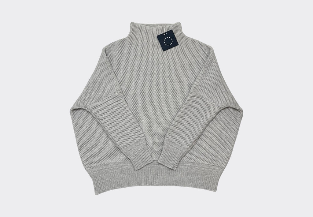 Front product shot 5ply Scottish cashmere grey colour dropped shoulder Skellig sweater navy swing tag visible with circle of stitches Sphere One logo