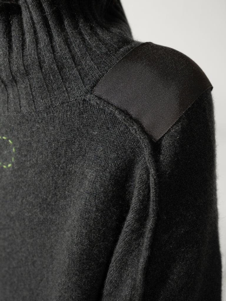 Close up of back of high neck grey cashmere sweater with grosgrain shoulder detail Sphere One logo circle of stitches
