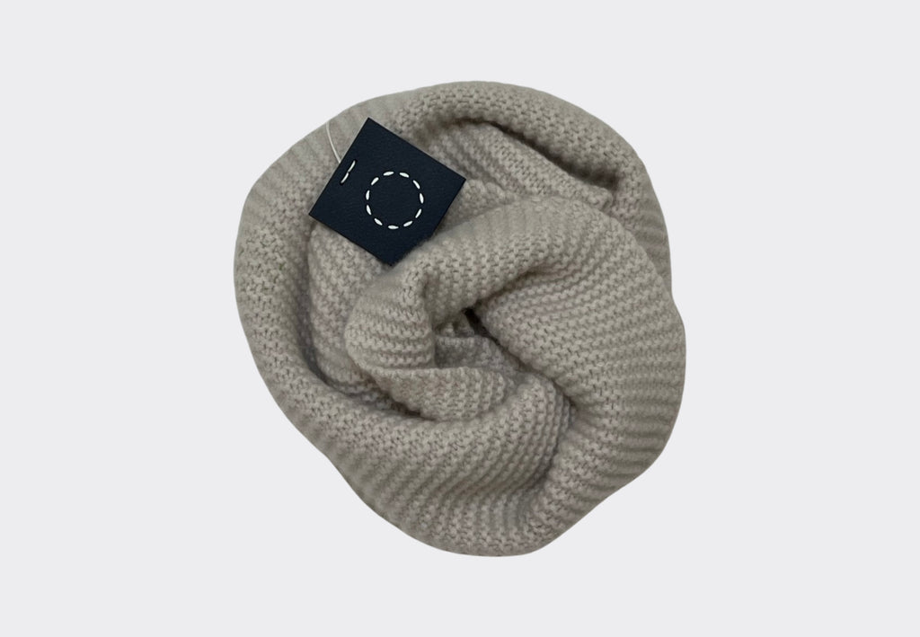Product shot of cream coloured chunky textured cashmere tube scarf with Sphere One Irish knitwear brand label navy swing tag