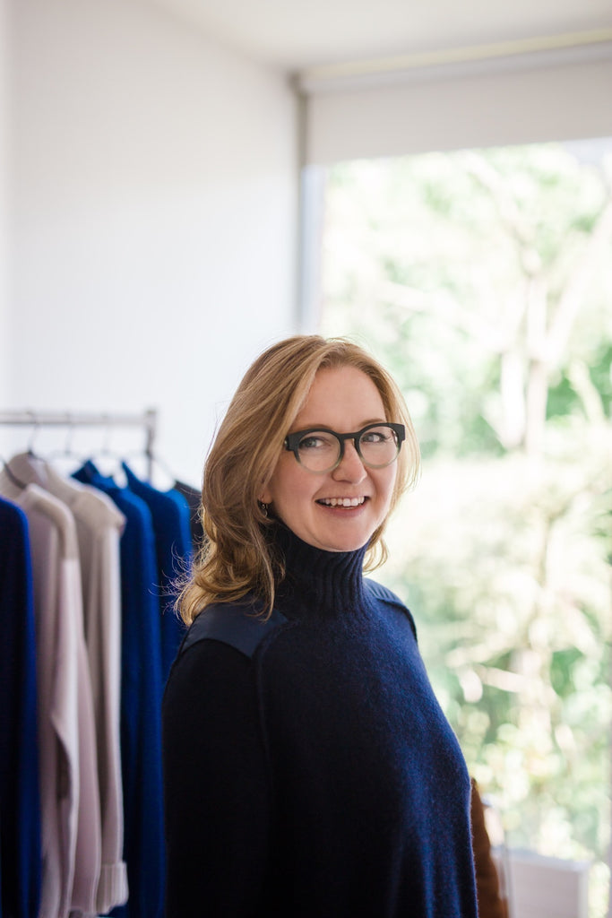 Lucy Downes Sphere One Irish designer in her studio against backdrop of original cashmere knit designs